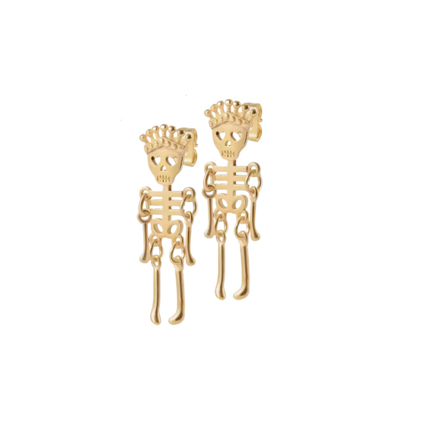 a pair of gold skeleton earrings