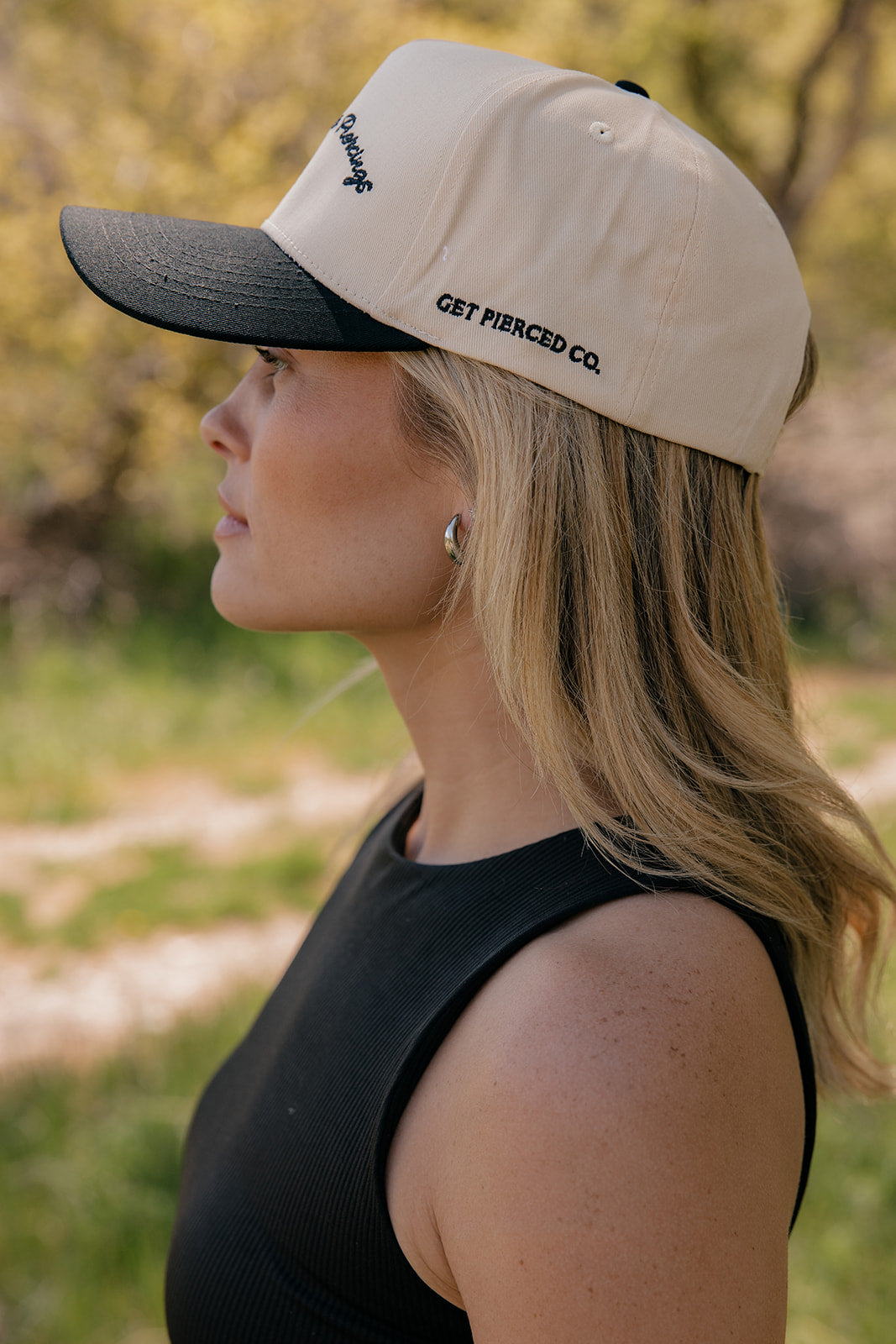 Show Me Your Piercings Trucker Hat in Black